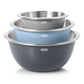 Set of three OXO stainless steel mixing bowls in gray, blue, and black on a white background
