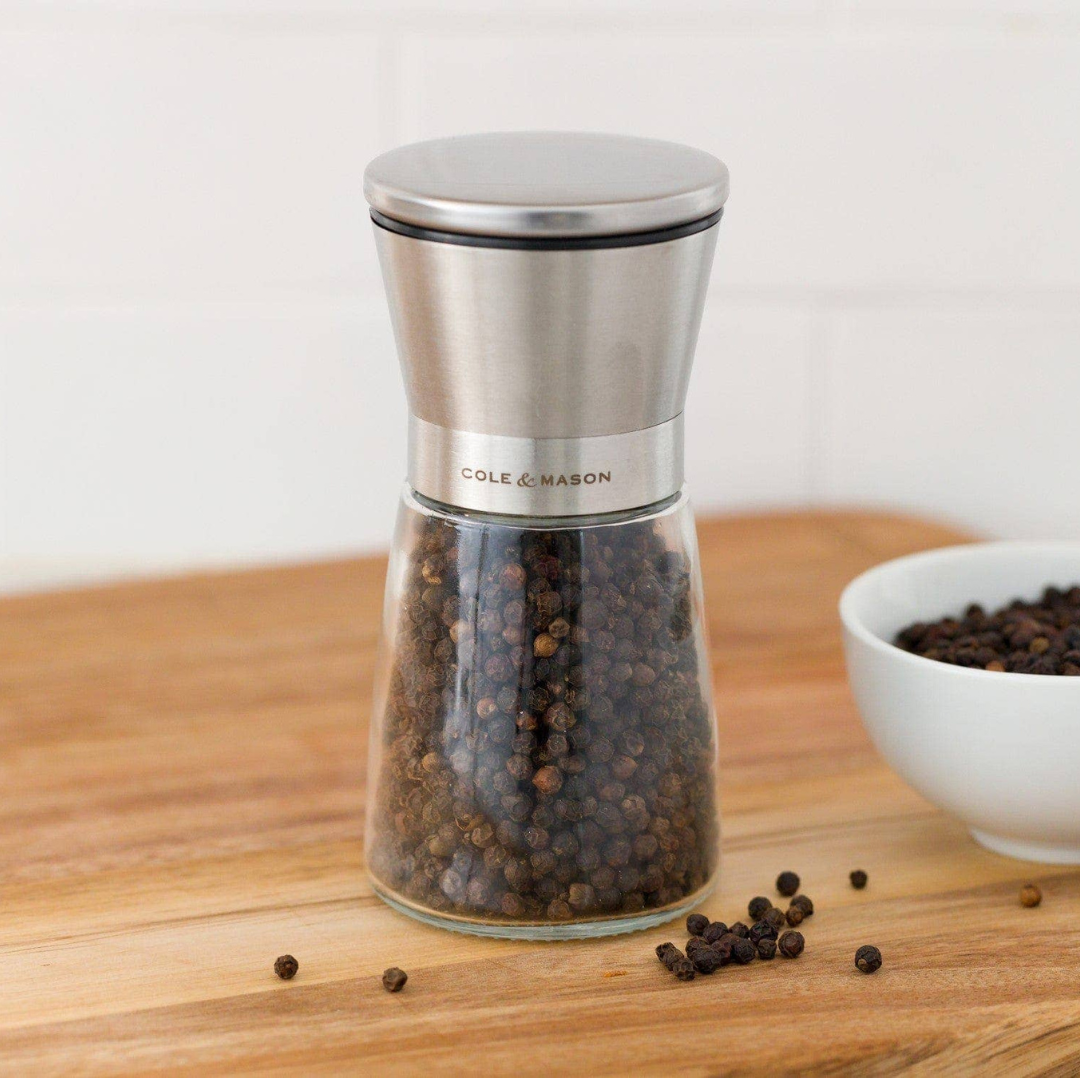 A modern and elegant salt and pepper mill set designed for a clean, mess-free kitchen. With the grinding mechanism positioned at the top, your countertops, cupboards, and dining table stay free of spills.