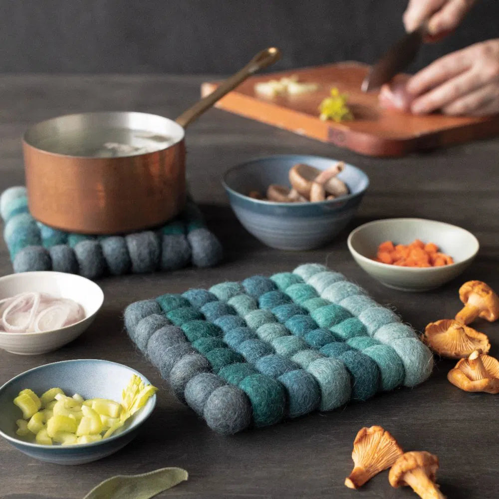 Add a splash of color and texture to your kitchen with the Trivet - Wool Felt Dots in Lagoon!