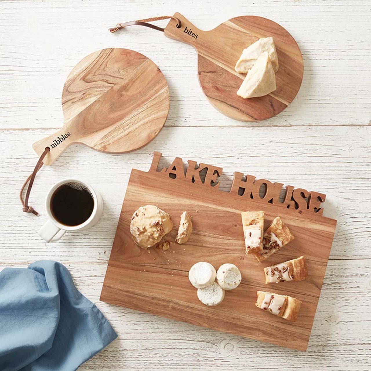 Dive into the charm of lakeside living with our "Lake House" Acacia Cutting Board! This versatile tray is not just a cutting board - it's a slice of lakefront luxury for your kitchen. Crafted from exquisite acacia wood, this board serves double duty as a stylish serving tray, perfect for hosting lakeside gatherings or adding a touch of rustic elegance to your dining table. 