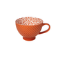 Orange textured mug with white interior pattern on a white background