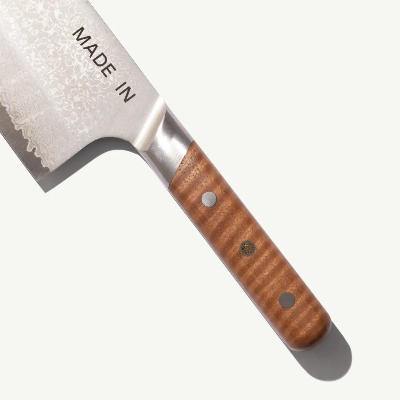 Knife with wooden handle and 'MADE IN' engraving on a white background