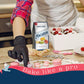 Person making macarons with a box of Angel Bake Macaron mix in a kitchen setting.