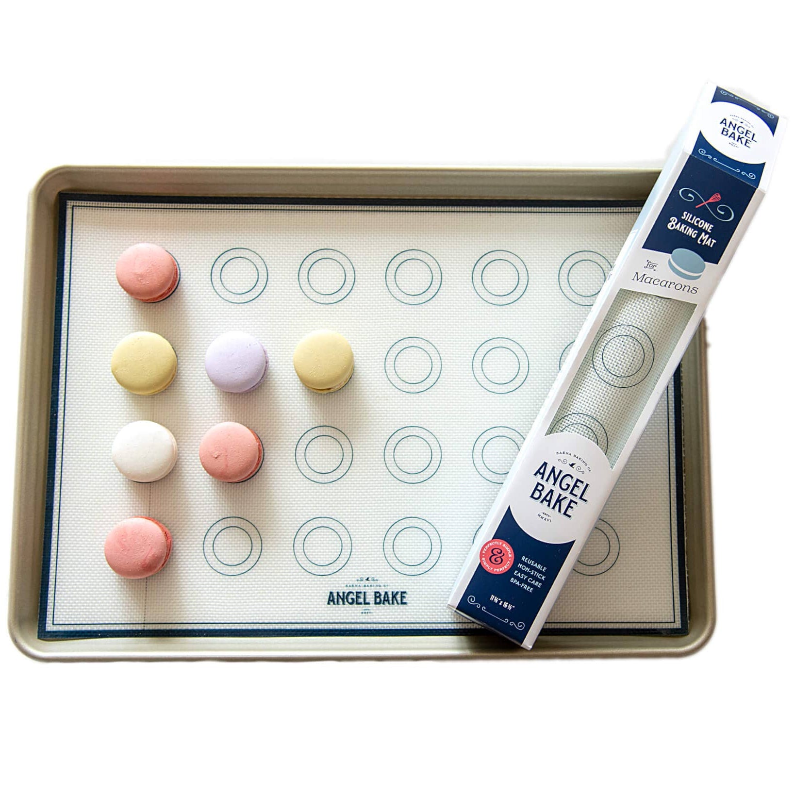 Baking sheet with macaron cookies and a piping bag on a white background