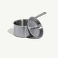 A stainless steel saucepan with a lid and a long handle, set against a white background.