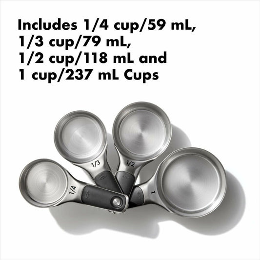 Set of 4 silver measuring cups with measurments on a white background