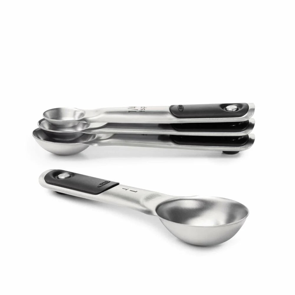 Set of metal measuring spoons stacked together. 