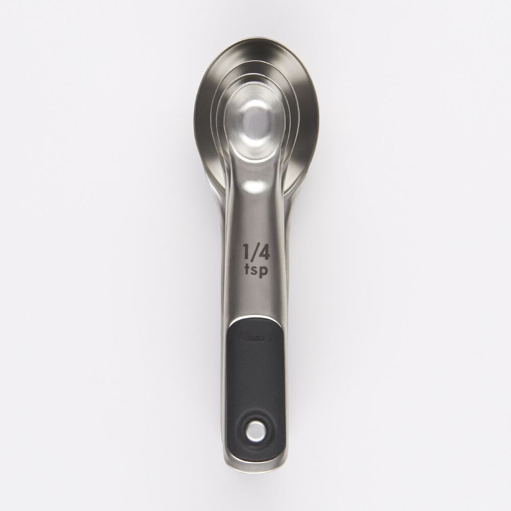 Top down of set of 4 measuring spoons on a white background. 