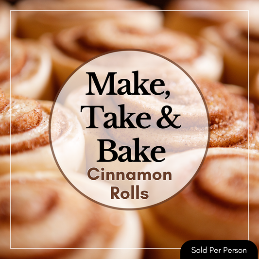 A square promotional graphic showing a close-up of cinnamon rolls in the background with a large central oval label reading 'Make, Take & Bake Cinnamon Rolls.' A small black badge in the bottom-right corner says 'Sold Per Person.