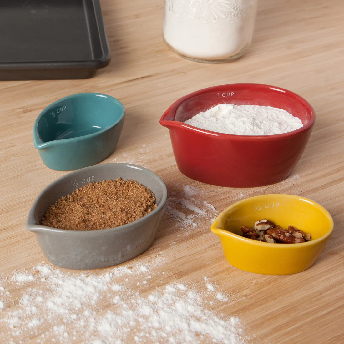 Set of 4 Danica Canyon measuring cup set made of stoneware. Comes in 1 cup, 2/3 cup, 1/3 cup and 1/4 cup.