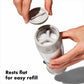 Hand holding salt grinder with rest flat salt refill. 
