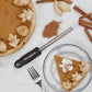 Spice grater on  table with pumpkin pie and cinnamon