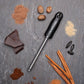 Spice grater on a grey slate surface with spices chocolate and nuts