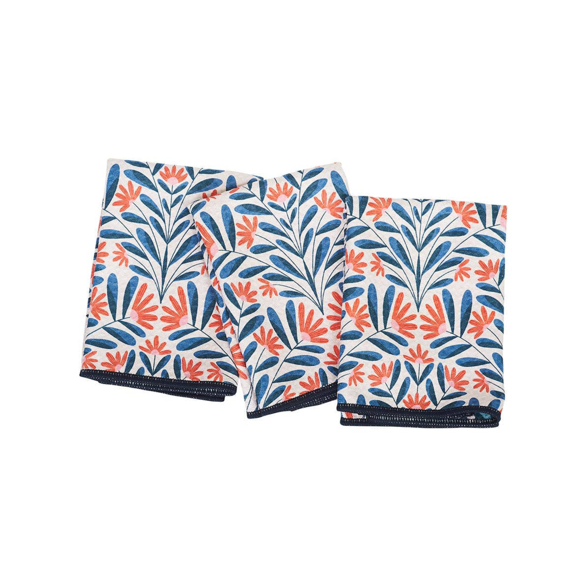 Three folded towels with a floral pattern on a white background