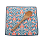 Patterned cloth with a wooden spoon on a white background