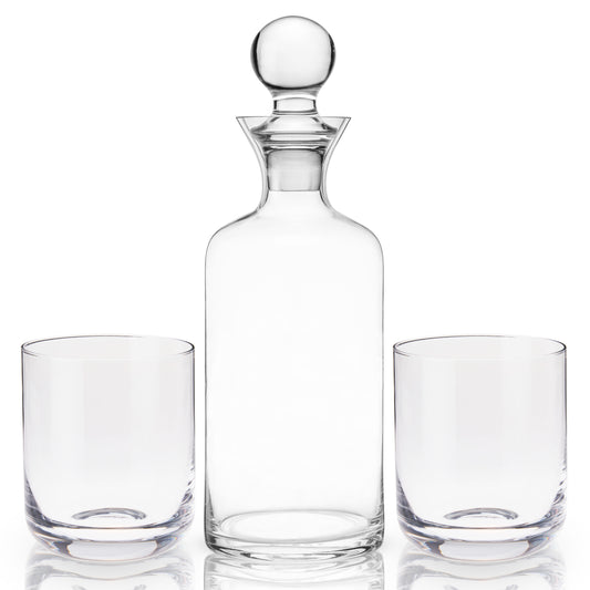 Hand-blown with pristine lead-free crystal, this gift set has superb weight and clarity— a perfect trio to elevate your favorite aged spirits. Includes the sleek decanter, rounded stopper, and two coordinating tumblers to serve and display your liquors at their best.  From graceful decanters to stylish coupes, Viski is dedicated to elegant design. Each collection explores a timeless bar style such as Art Deco or mid-century modern for a refined addition to your glassware collection.