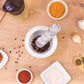 Mortar and pestle with spices on a wooden surface