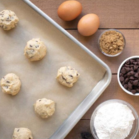 Baking ingredients and process on a wooden surface