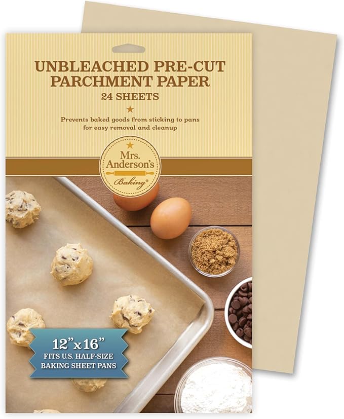 Unbleached pre-cut parchment paper package with baking items on a wooden surface