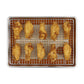 A top-down view of nine golden-brown fried chicken wings arranged on a wire cooling rack set inside a rectangular metal baking tray, isolated on a white background.