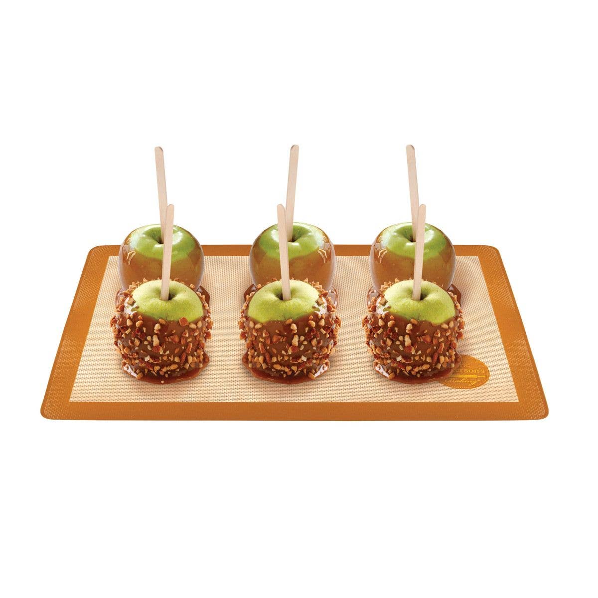 Four caramel apples on a wooden tray with a white background