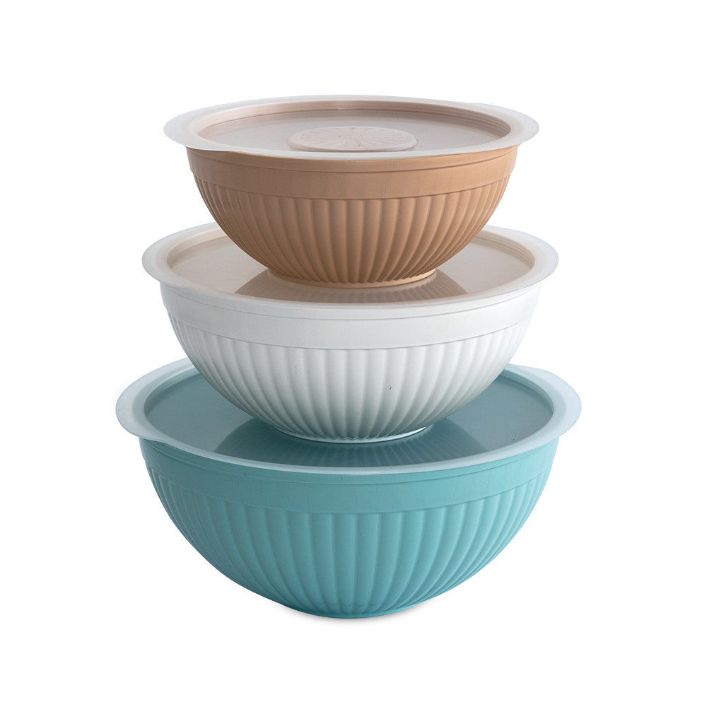 Set of three mixing bowls in brown, white, and blue on a white background