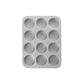Metal muffin tin with 12 compartments on a white background