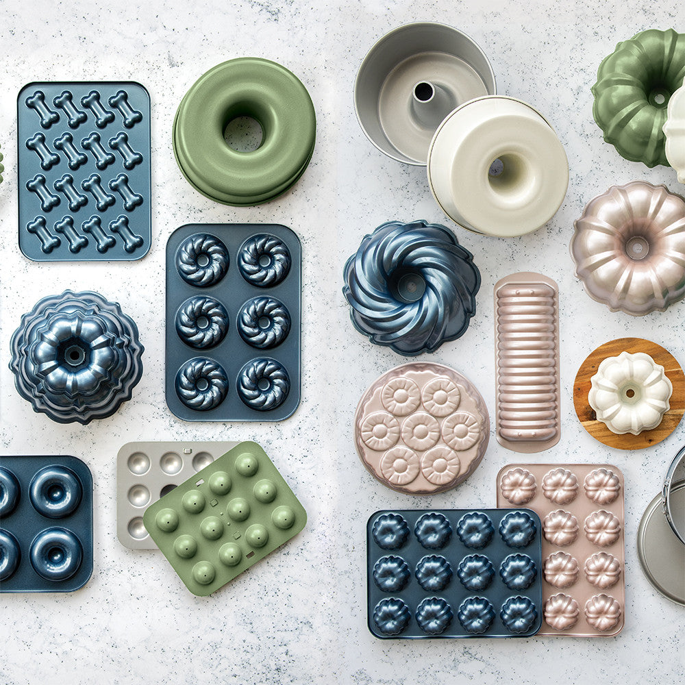 Collection of various baking molds on a textured surface