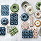Collection of various baking molds on a textured surface