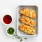 Three cheesy bread slices on a tray with a small bowl of red sauce and another with green herbs on a white background.