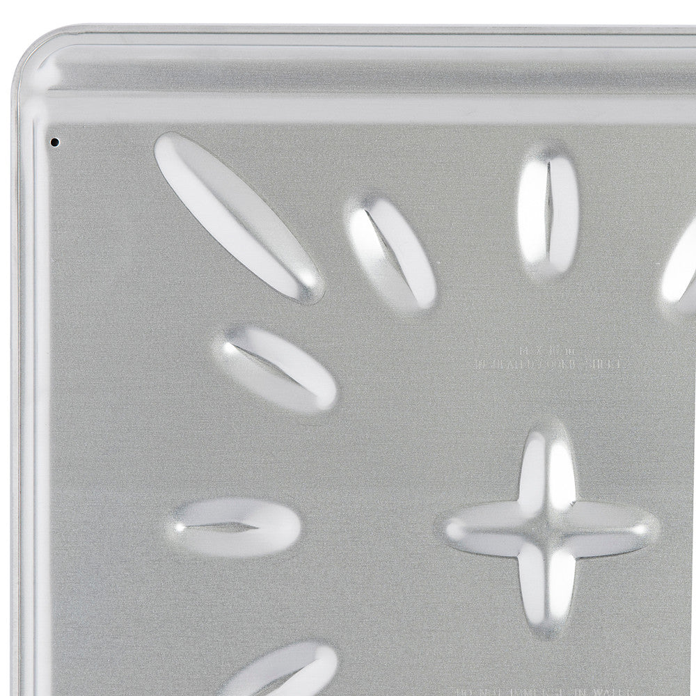 Close-up of a metallic pan with circular indentations