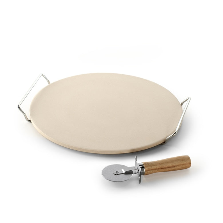 Round pizza stone with metal handle and pizza cutter with wooden handle on a white background