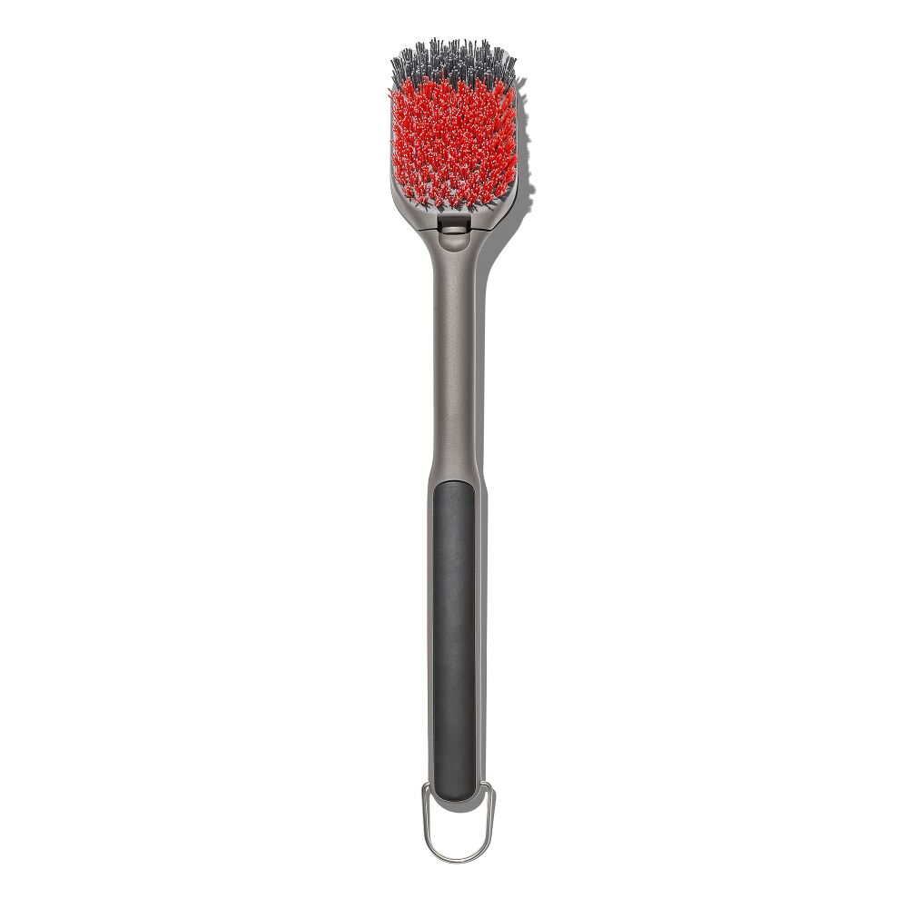 Barbecue brush with red bristle head and black handle on a white background