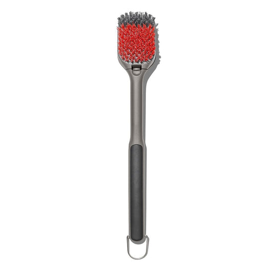 Barbecue brush with red bristle head and black handle on a white background