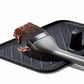 Basting brush with brown sauce on a black tray