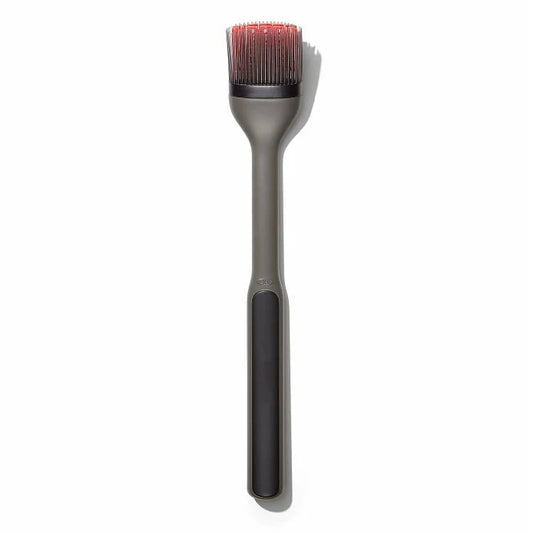 Barbecue brush with bristle head and black handle on a white background