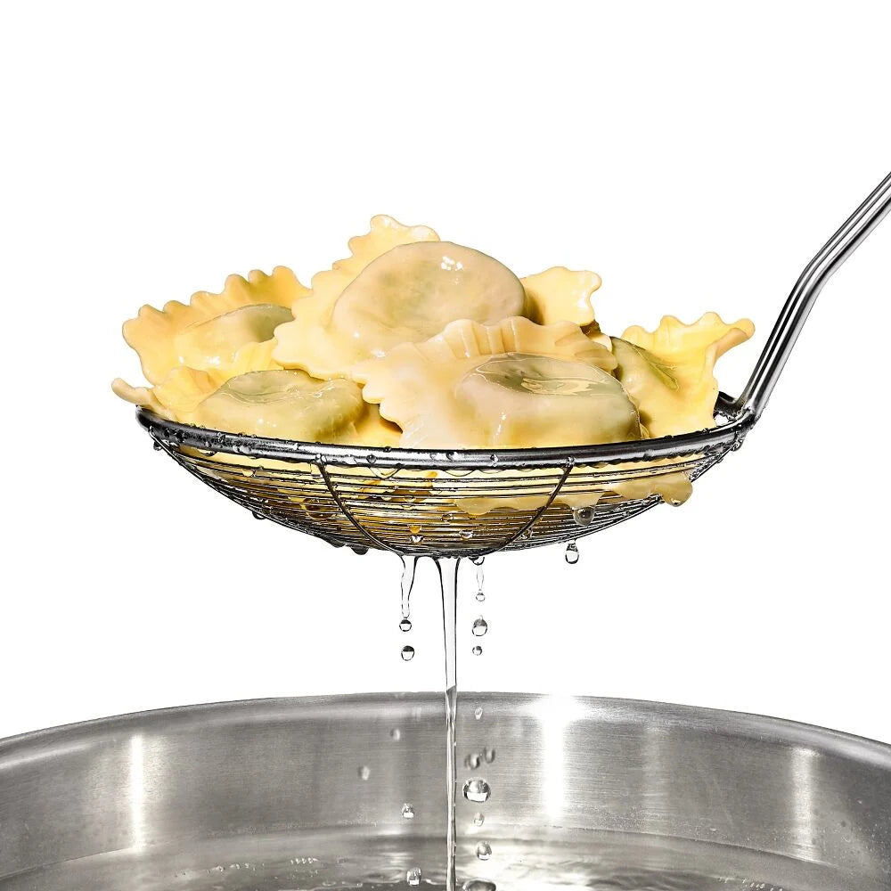 Ravioli being drained in a metal strainer over a pot of water.