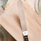Offset Spatula with a black handle on a wooden cutting board