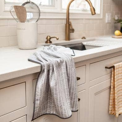 Kitchen sink area with a towel hanging over the counter