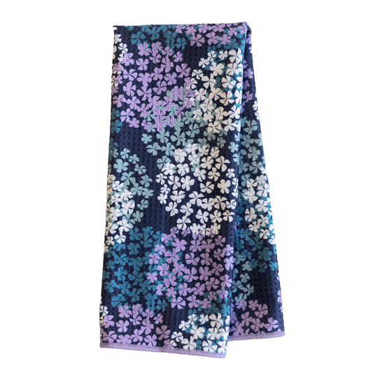 Folded towel with floral pattern on a white background