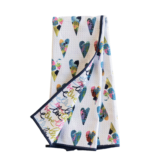 Folded towel with colorful heart pattern on a white background