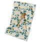 Floral patterned towel with a wooden spoon on a white background