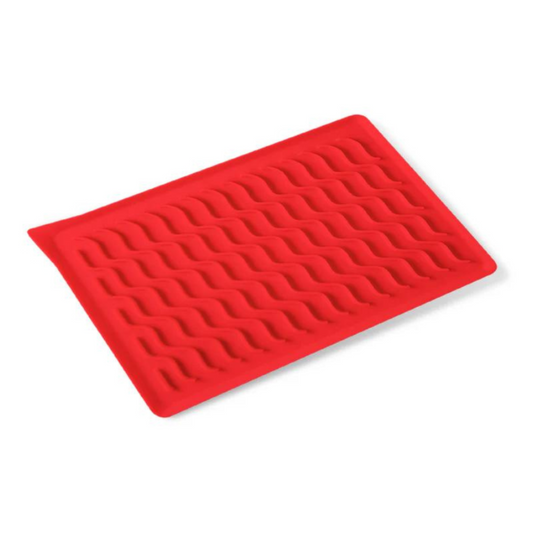 A red silicone bacon mat with raised ridges and a built-in spout for grease collection.