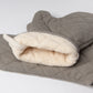 Gray quilted oven mitt with white interior on a light gray background