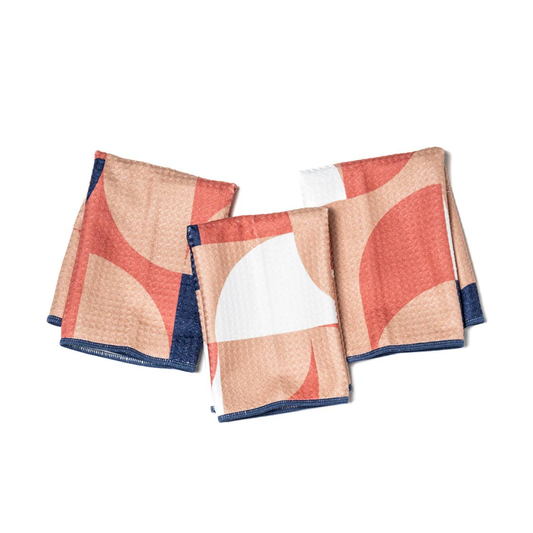 Set of three patterned towels on a white background