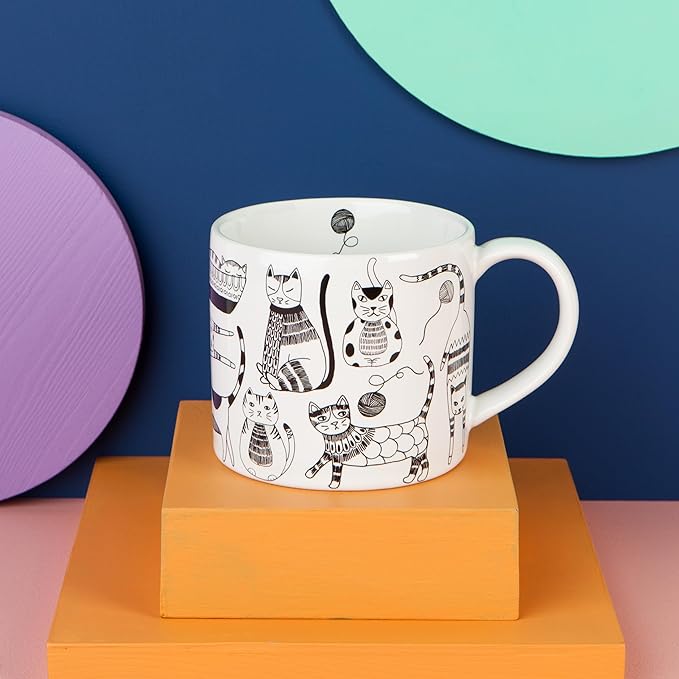 Mug in a Box - Purr Party from Danica Jubilee! This enchanting set features a delightful ceramic mug, adorned with whimsical cat designs that are sure to bring a smile to any feline lover's face. Each 14-ounce stoneware mug comes beautifully packaged in a gift-ready box