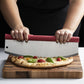 Rocking Pizza Cutter with Blade Guard being used to cut a pizza on a dark wood cutting board. 
