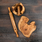 olive wood rolling pin on table with other olive wood tools