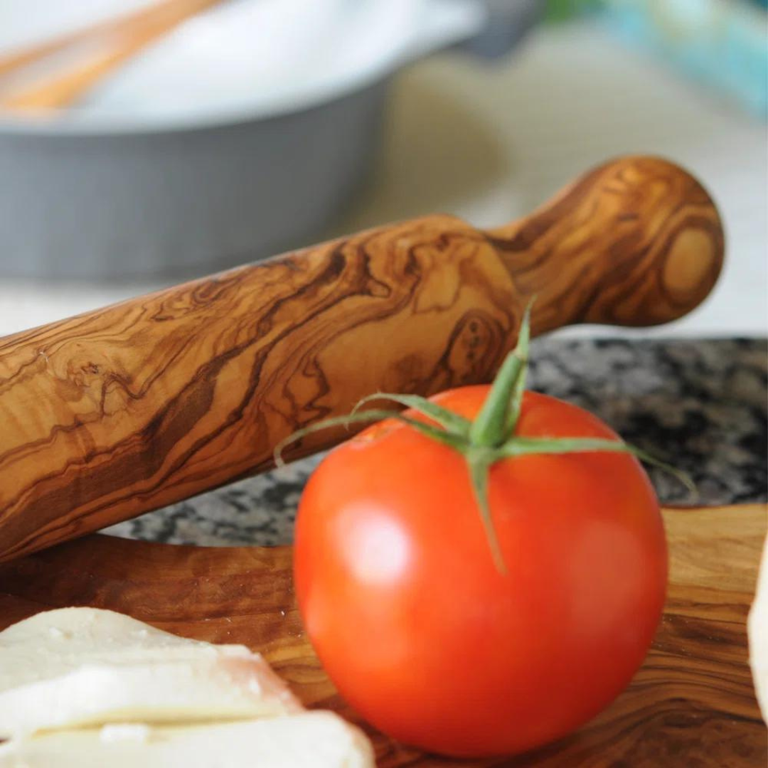 olive wood rolling pin  on counter with tomato