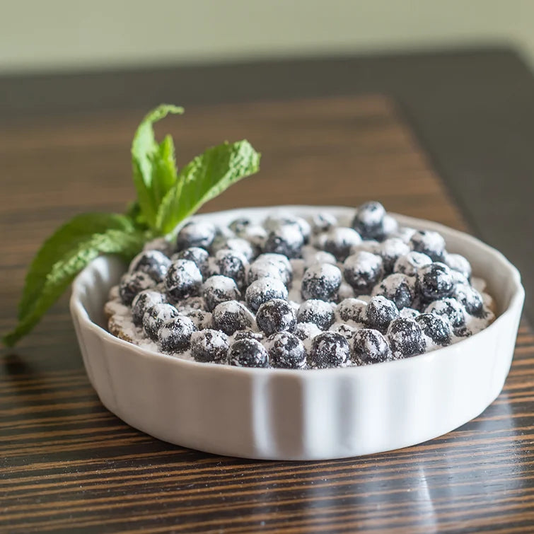 White round quiche/brulee baking dish with blueberry dessert